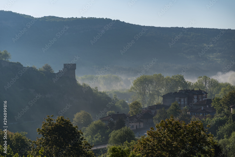 Morning fog over valley. Tower of Tsarevets Fortress in Veliko Tarnovo, Bulgaria