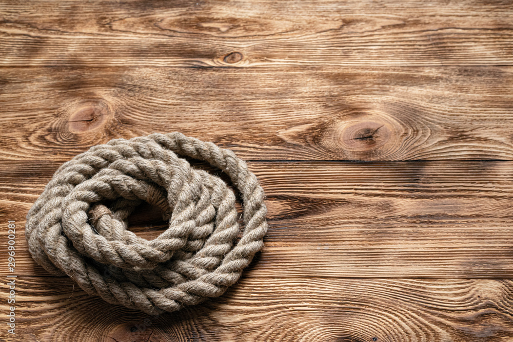 Rope on brown wooden floor background with copy space. Rope on brown wooden floor background with copy space.