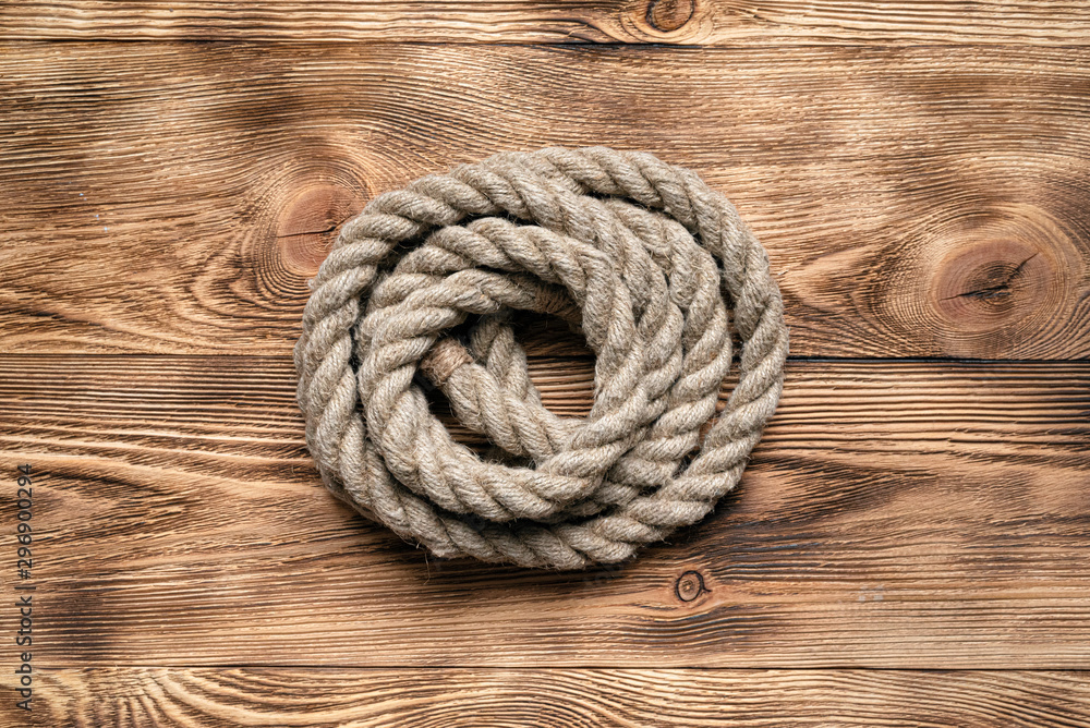 Rope on brown wooden floor background with copy space. Rope on brown wooden floor background with copy space.
