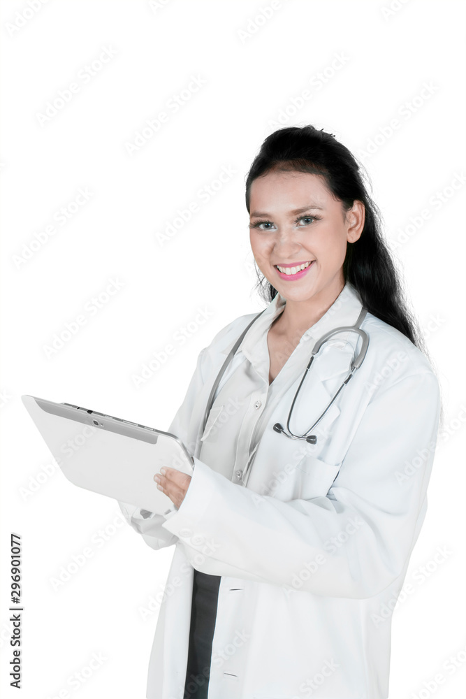 Smiling female doctor holding a tablet on studio Smiling female doctor holding a tablet on studio