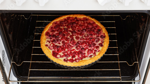 Homemade raspberry pie with yogurt filling cooked in the domestic oven. Shallow focus.