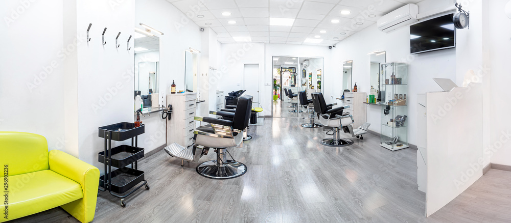 Panorama of a modern bright hair and beauty salon. Barber salon interior business with black and white luxury decor. - obrazy, fototapety, plakaty 