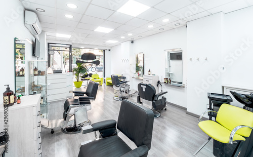 Panorama of a modern bright hair and beauty salon. Barber salon interior business with black and white luxury decor.