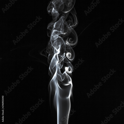 Abstract white smoke swirls pattern over the black background