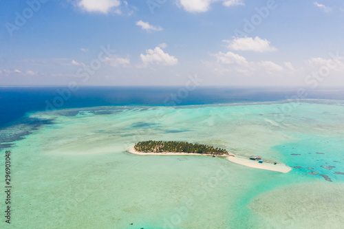 Onok Island Balabac, Philippines. The island of white sand on a large atoll, view from above. Tropical island with palm trees. Seascape with a paradise island.