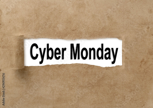 Text Cyber Monday appearing behind ripped brown paper. © banphote