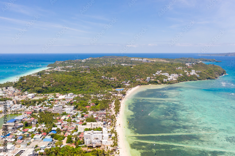 Houses and streets on the island of Boracay, Philippines, top view. Hotels and buildings on the big island. Landscape on a sunny day.