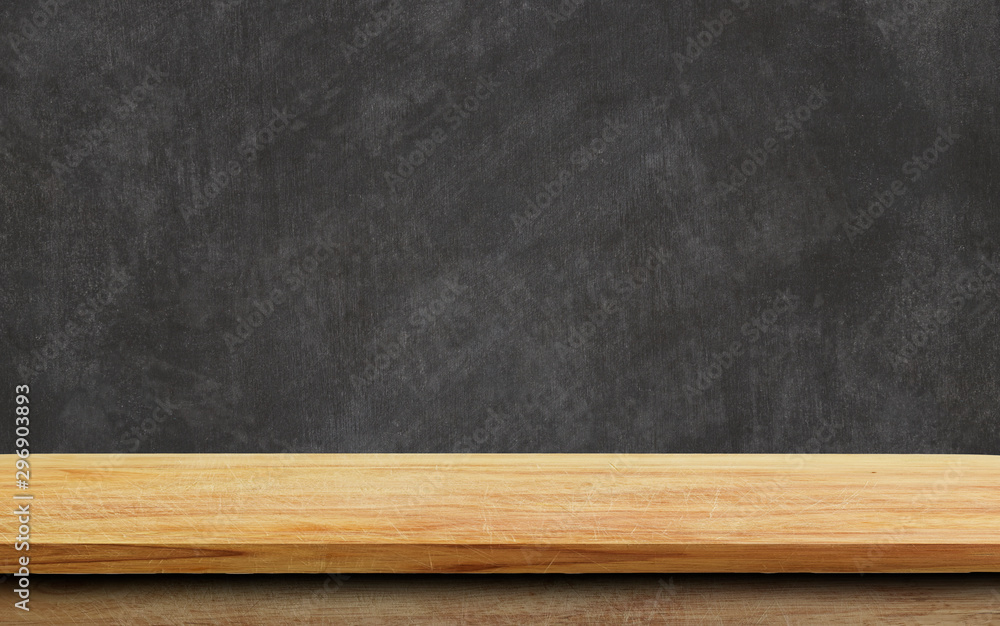 Empty wood table top on chalkboard background.