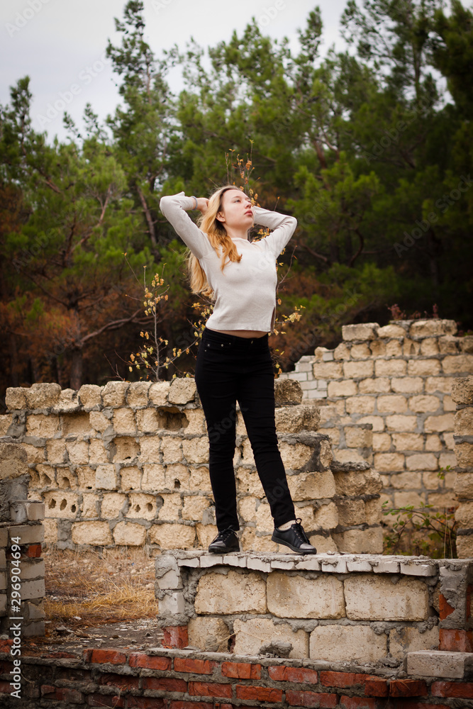 beautiful girl stands on stone wall beautiful girl stands on stone wall
