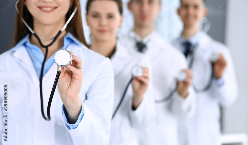 Group of doctors holding stethoscope head close-up. Physicians ready to examine and help patient. Medical help, insurance in health care, best treatment and medicine concept Group of doctors holding stethoscope head close-up. Physicians ready to examine and help patient. Medical help, insurance in health care, best treatment and medicine concept