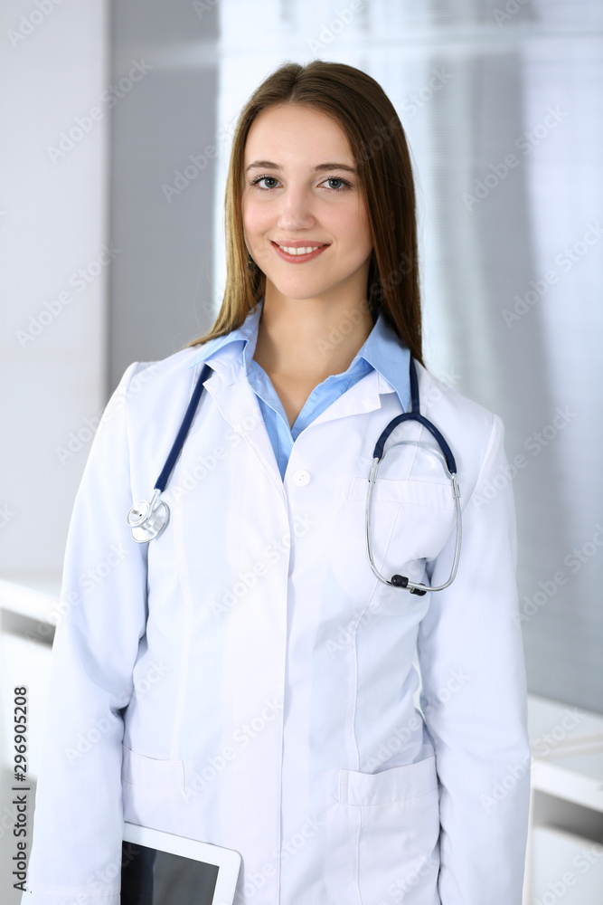 Doctor woman happy and cheerful while standing in hospital office at highlight background. Medicine and healthcare concept Doctor woman happy and cheerful while standing in hospital office at highlight background. Medicine and healthcare concept