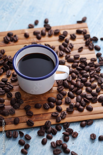 Coffee in cup and coffee bean on rustic table with a blank space for a text, Espresso in cup on blue background
