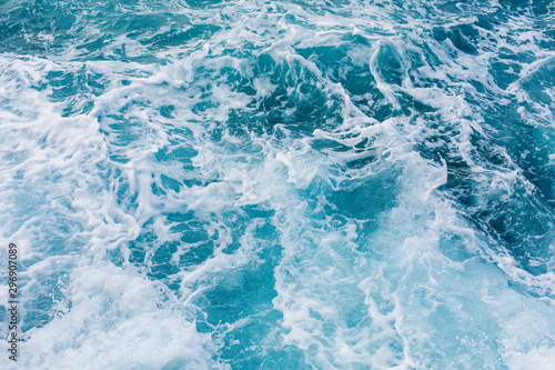 Turquoise sea surface background with splashing waves