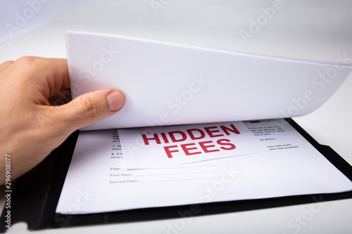 Person Looking At Hidden Fees In Contract