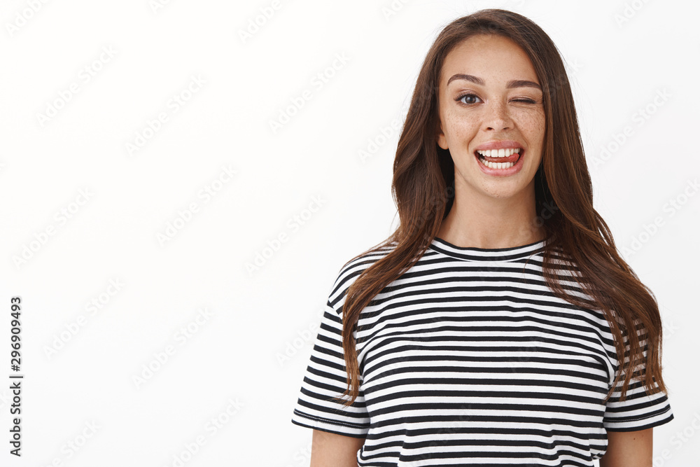 Close-up lucky carefree brunette female in striped t-shirt staying positive, feel accomplished and upbeat, showing tongue playfully, making goofy grimace, standing white background Close-up lucky carefree brunette female in striped t-shirt staying positive, feel accomplished and upbeat, showing tongue playfully, making goofy grimace, standing white background