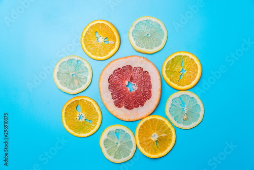 bright slices of oranges and grapefruit on a blue background