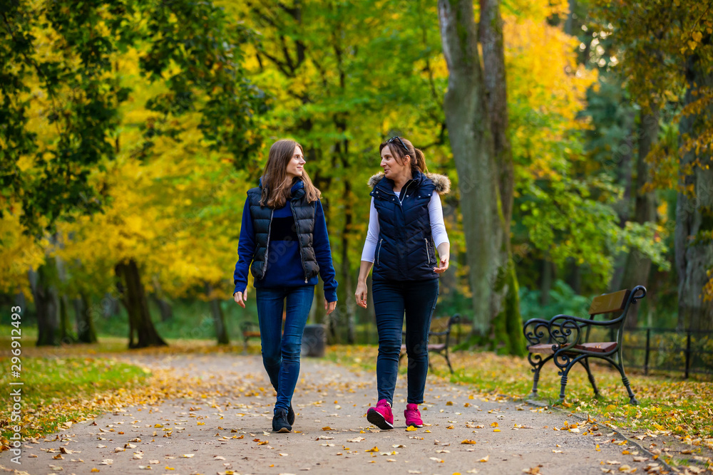 Fototapeta premium People walking in city park
