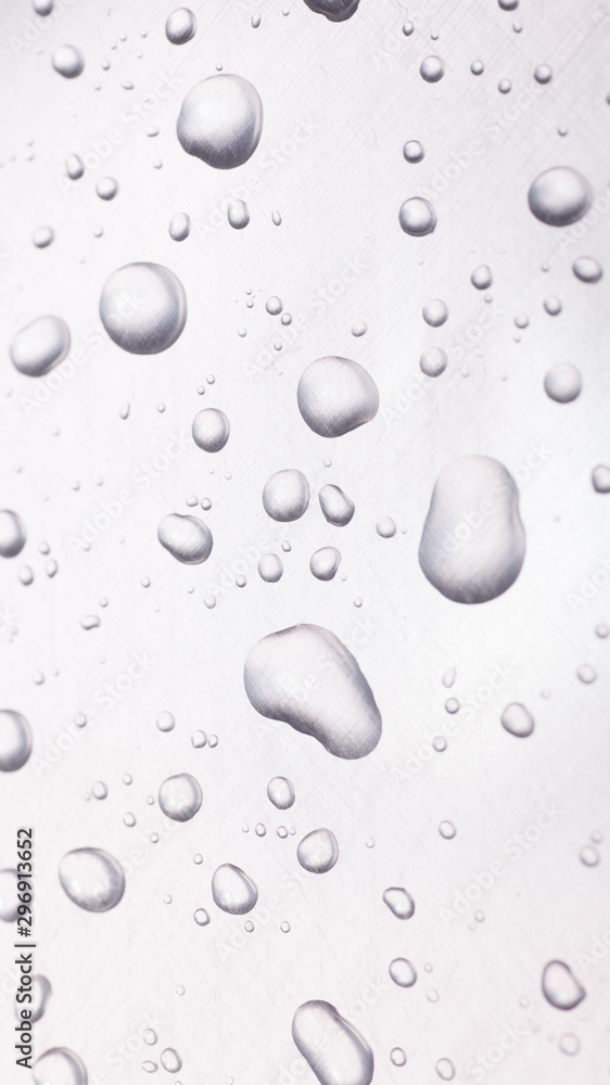 dots of water on light metal surface, macro background, vertical shot