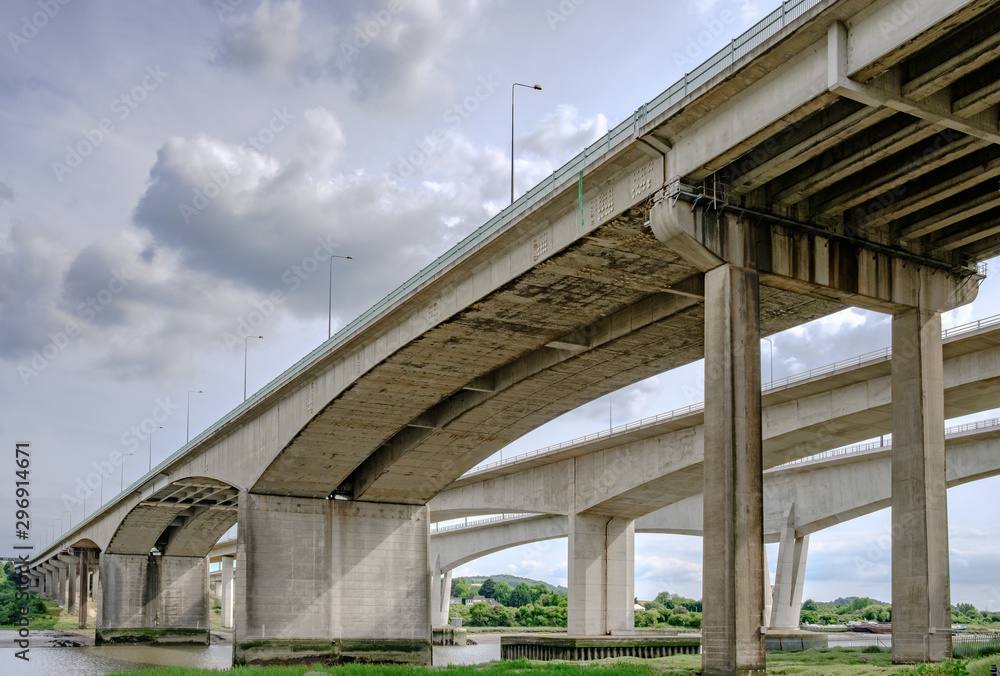 Close-up, structural view of the impressive architecture and construction of a major motorway, spanning a River in the United Kingdom. Close-up, structural view of the impressive architecture and construction of a major motorway, spanning a River in the United Kingdom.