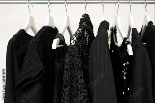 Φωτογραφία set of women's clothing in black in different colors on hangers, a concept for f