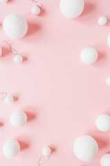 Christmas / New Year holiday composition. Mock up frame with blank copy space made of Christmas bauble balls on pink background. Flat lay, top view festive concept.