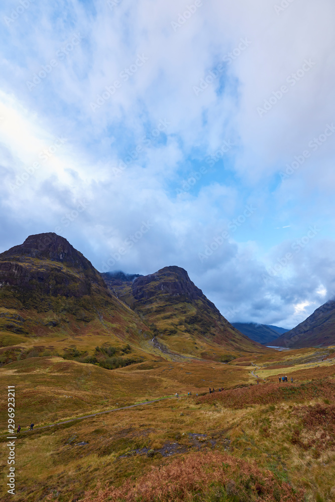 Looking down Glencoe to the West, with walkers on the West Highland way making their way along the Footpath on a wet Octobers day.