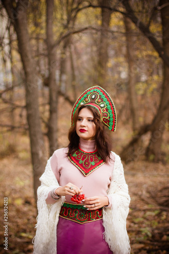 young woman in traditional folk costume in the forest