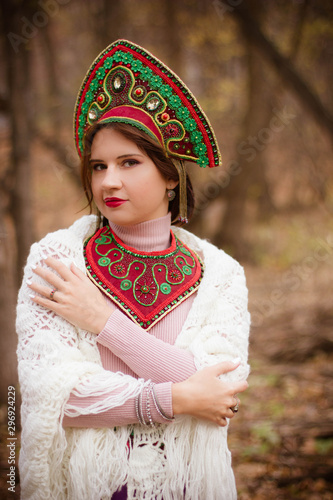 young woman in traditional folk costume in the forest