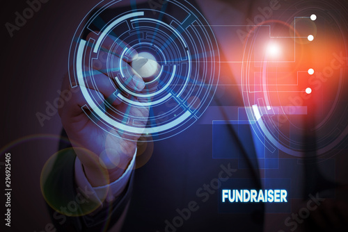 Conceptual hand writing showing Fundraiser. Concept meaning demonstrating whose job or task is seek financial support for charity Male wear formal suit presenting presentation smart device
