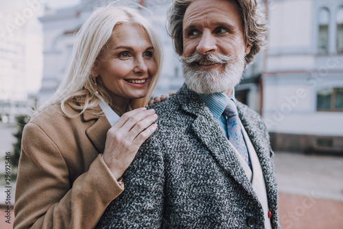 Smiling mature couple is walking in the city