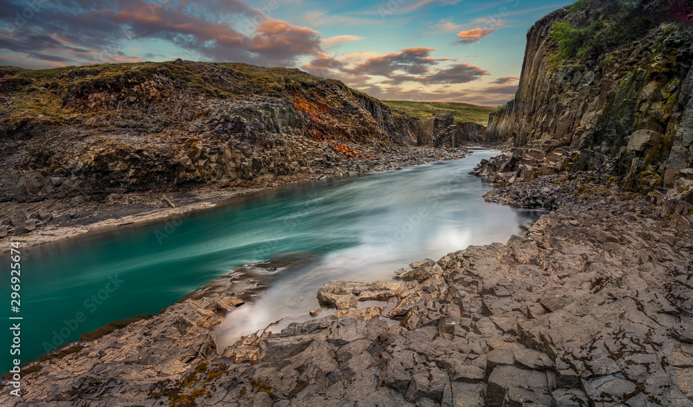 Beautiful basalt canyon Studlagil at the sunset