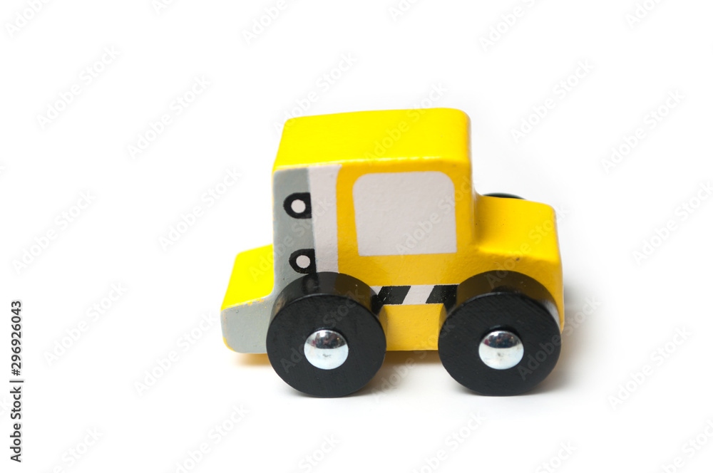 Closeup of miniature toy, wooden yellow car on white background