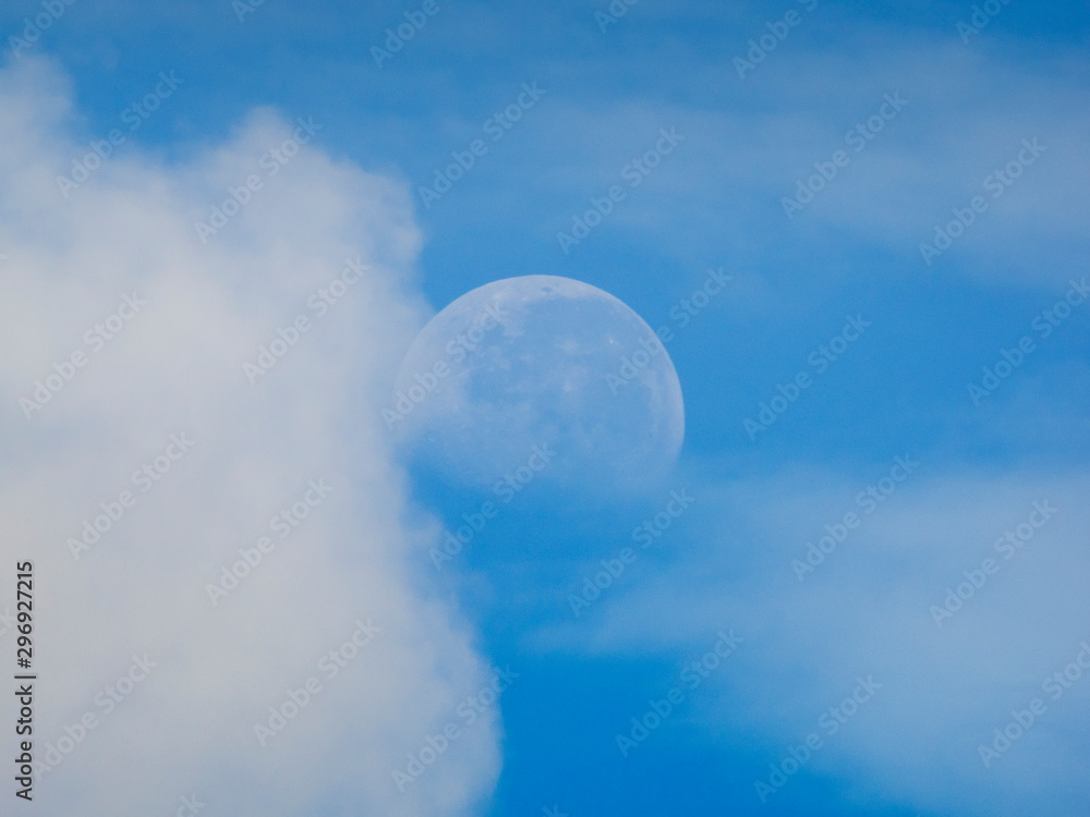 view morning of full moon 70% falling around with white clouds and blue sky background. view morning of full moon 70% falling around with white clouds and blue sky background.