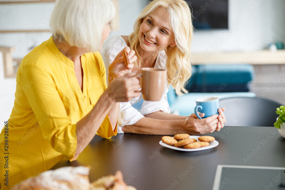 Pretty adult woman talking to her mother Pretty adult woman talking to her mother