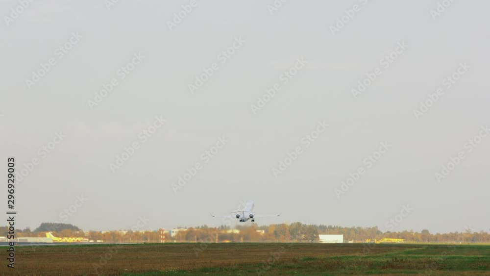 Jet airplane takes off in the distance on a clear morning day Jet airplane takes off in the distance on a clear morning day
