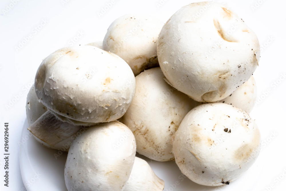 Champignon mushrooms in a plate on a white background isolate Champignon mushrooms in a plate on a white background isolate