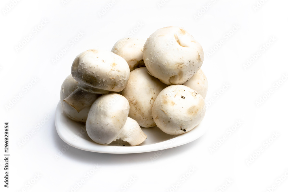 Champignon mushrooms in a plate on a white background isolate Champignon mushrooms in a plate on a white background isolate