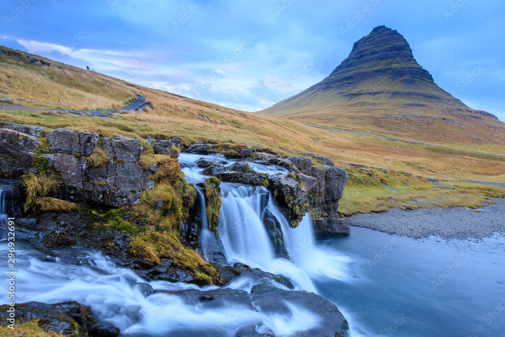 Fototapeta premium Iceland timelapse photography of waterfall and famous mountain. Kirkjufellsfoss and Kirkjufell in northern Iceland nature landscape