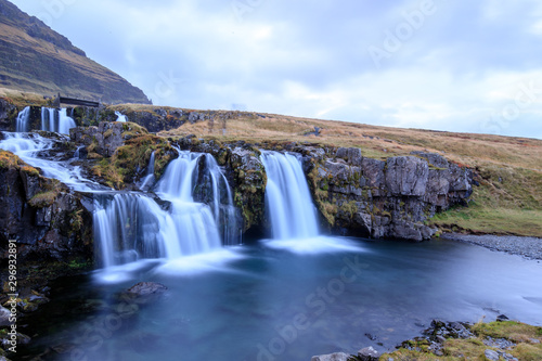 Iceland timelapse photography of waterfall and famous mountain. Kirkjufellsfoss and Kirkjufell in northern Iceland nature landscape