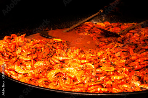 Cooking shrimp on the grill with sauce.