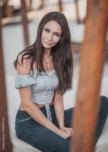 Young woman sitting in a beach chair © Smith