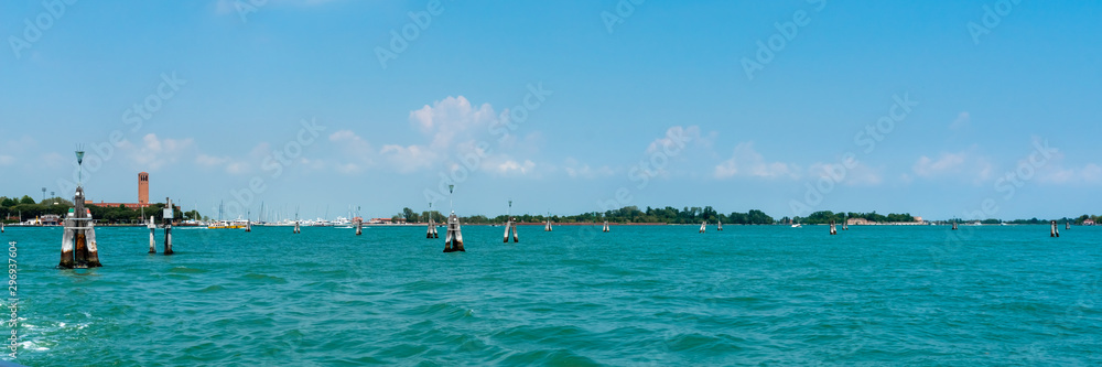 Obraz premium Venice. Island Lido. Panoramic view of beautiful Venetian lagoon. Yachts on the horizon on blue sky background. Header. Banner. 