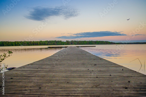 Fototapeta Naklejka Na Ścianę i Meble -  Beautiful landscape with wooden water floater and cloud passing by the horizon during a tranquil day