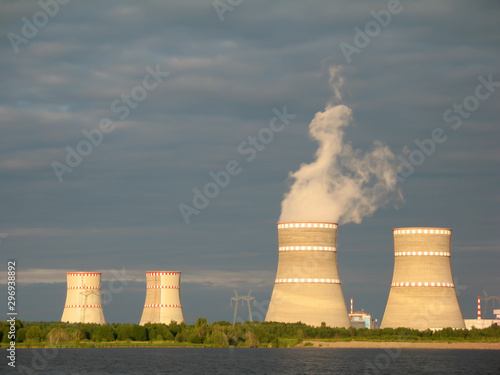 Water-cooling towers of nuclear power plant illuminate by sunset light. Udomlya, Russia photo