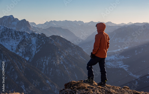 Hiker on top of the mountain valley view dusty sunsest photo