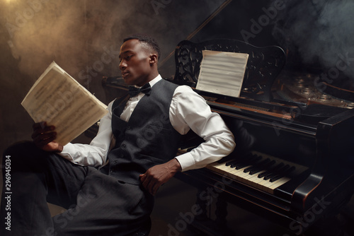 Wall Mural Black pianist with music notebook, jazz musician