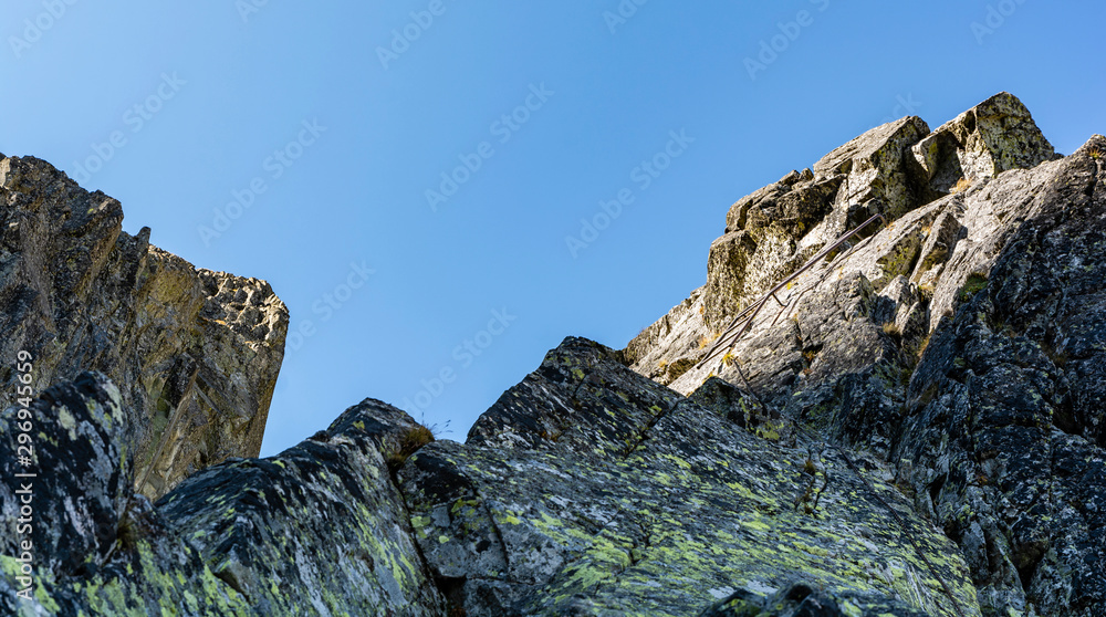 A metal ladder that makes it easier to overcome a steep and without good grips of the rock step in the mountains. A metal ladder that makes it easier to overcome a steep and without good grips of the rock step in the mountains.
