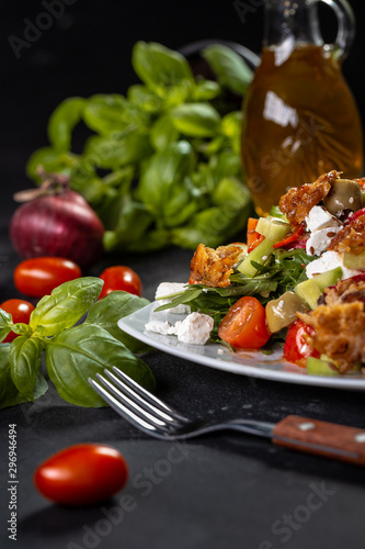 Healthy salade with basil, tomato, olive oil, spanach, feta cheese. Closeup of vegetable