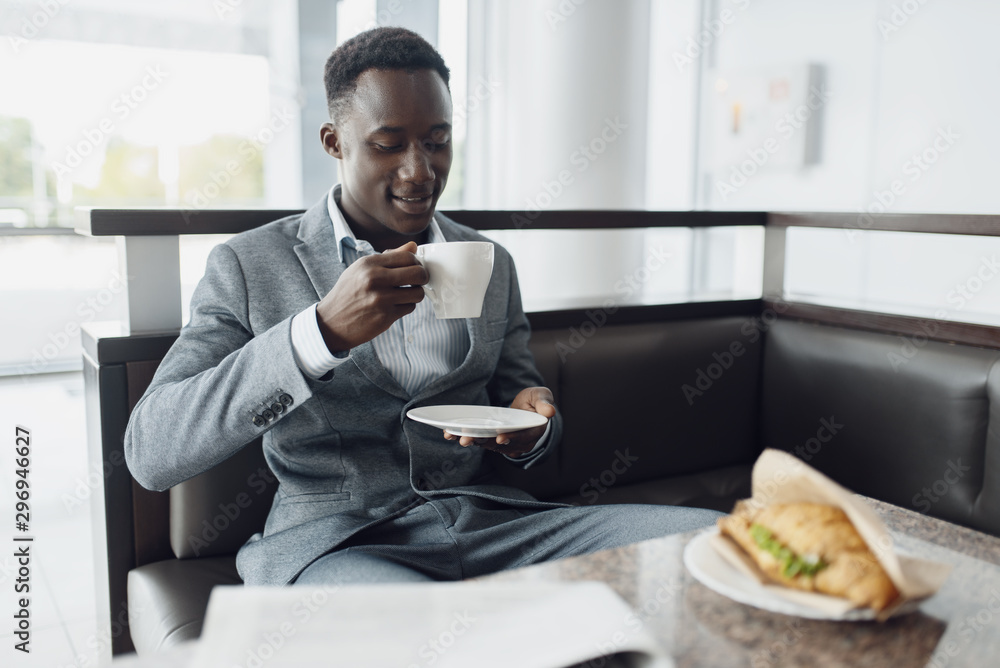 Black businessman having lunch in office cafe