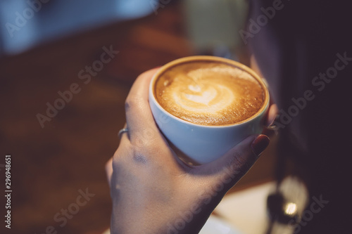 woman hands holding a cup of coffee ,Drinking coffee